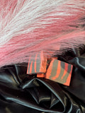 Coral and gray striped handmade soap bars on dark satin fabric